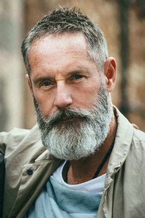 Shoulder-Length Silver Waves with Light Beard