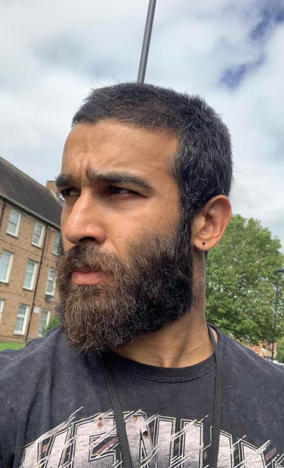 Refined Masculinity with a Tapered Haircut and Thick Medium Beard
