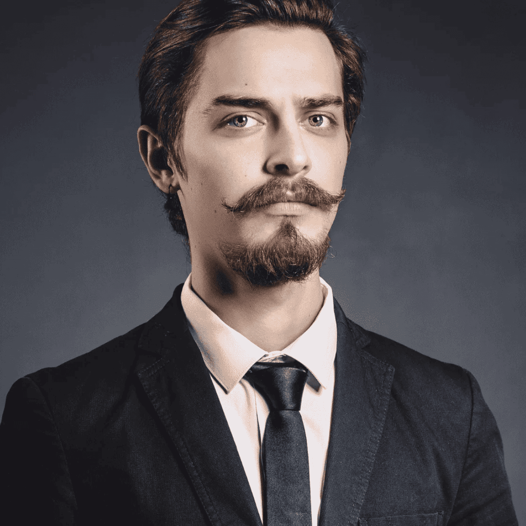 Portrait of a man with buzz cut and an anchor beard